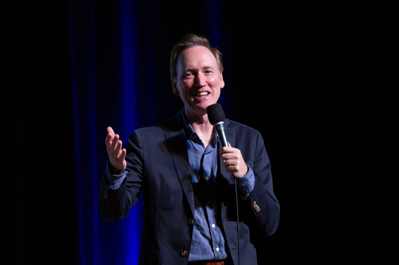 Comedian performing stand-up on stage